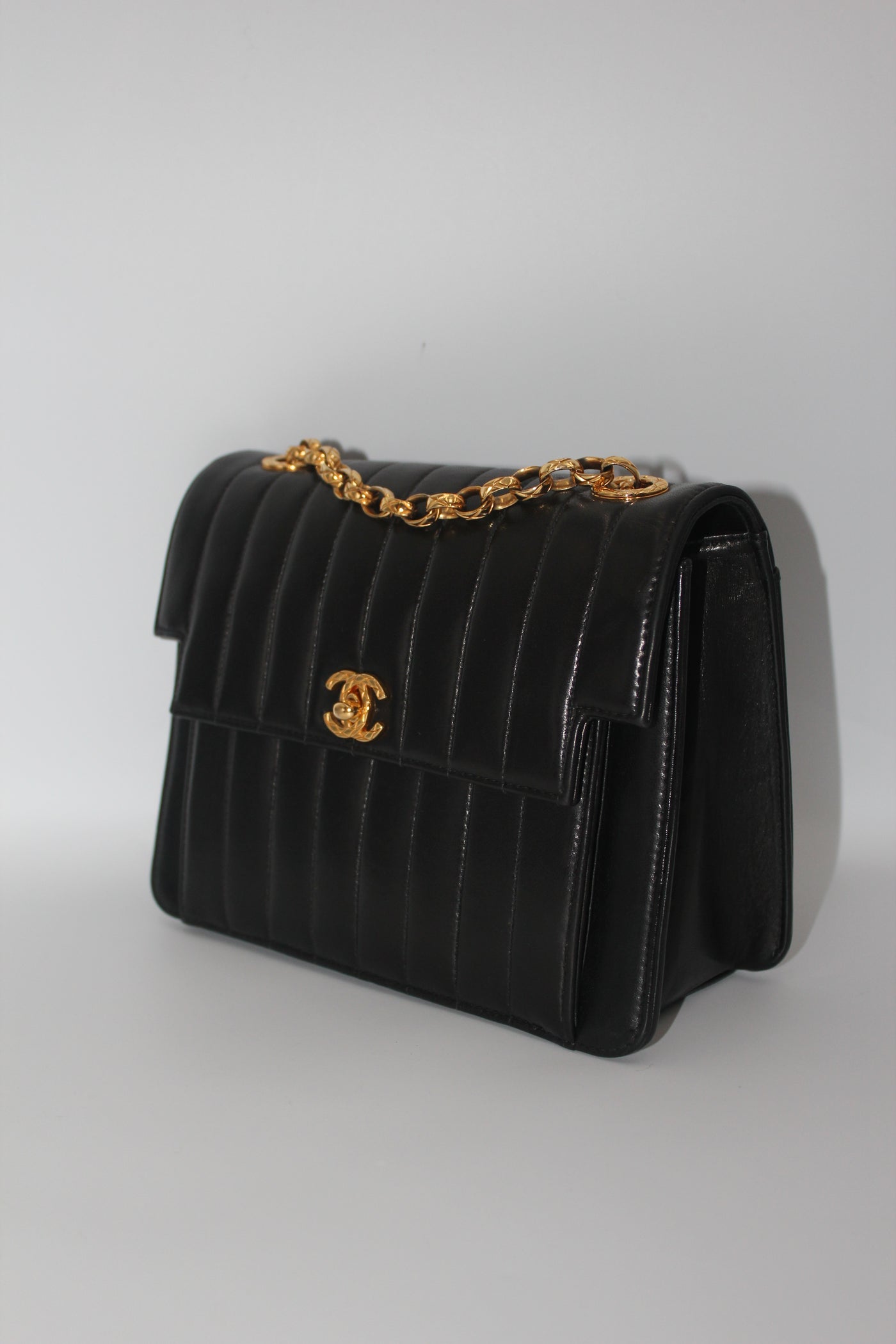 CHANEL rare black vertical handbag with 24 carat gold plated bijoux chain