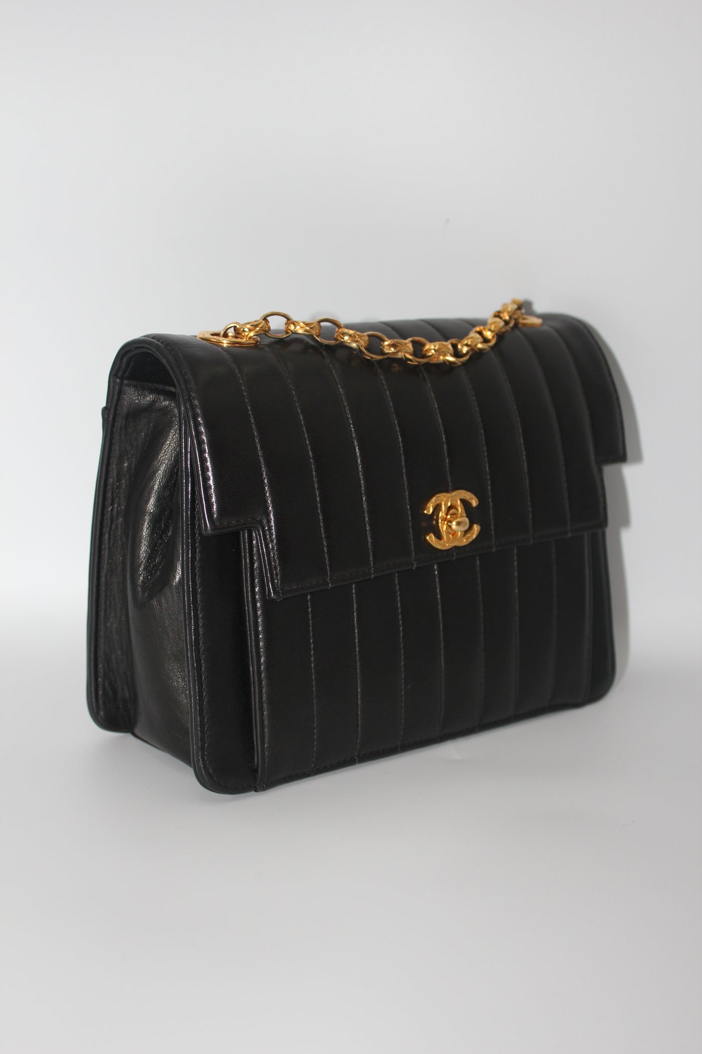 CHANEL rare black vertical handbag with 24 carat gold plated bijoux chain