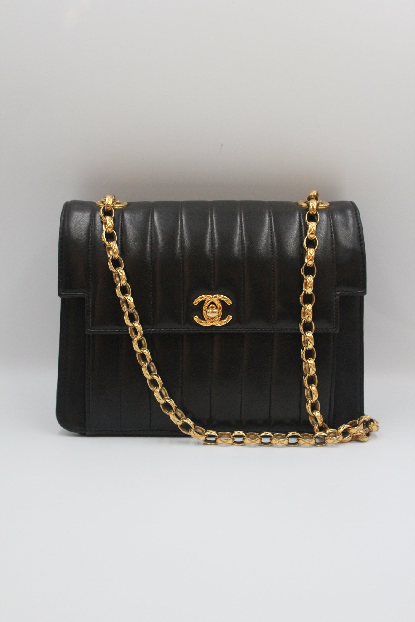 CHANEL rare black vertical handbag with 24 carat gold plated bijoux chain