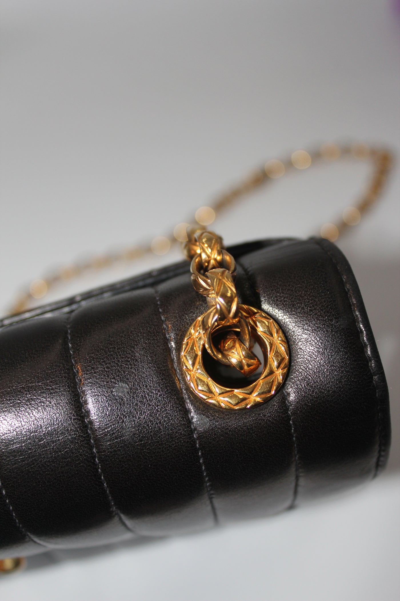 CHANEL rare black vertical handbag with 24 carat gold plated bijoux chain